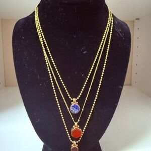 Tory Burch Elegant Gold Multi-Layer Necklace with colorful pendants.